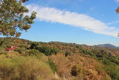 a view of a hill with a house on it at Gîte des Orgues d'Ille les Agaves Canigou in Ille-sur-Têt