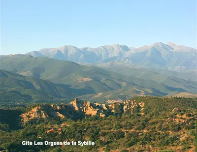 a view of a mountain range with mountains in the background at Gîte des Orgues d'Ille les Agaves Canigou in Ille-sur-Têt