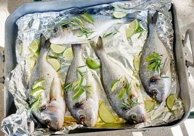 a bunch of fish sitting on foil in a pan at Domaine Des Agnelles in Villedaigne