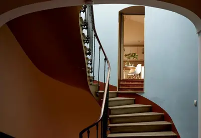 a spiral staircase in a house with a mirror at Domaine Des Agnelles in Villedaigne
