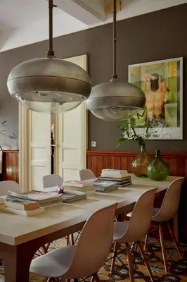 a dining room table with chairs and pendant lights at Domaine Des Agnelles in Villedaigne