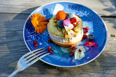 a blue plate with a pastry on a table with a fork at Domaine Des Agnelles in Villedaigne