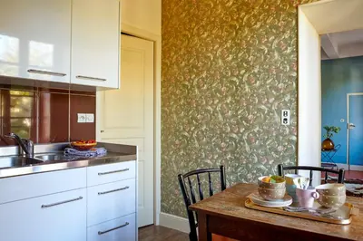 a kitchen with a table with chairs and a sink at Domaine Des Agnelles in Villedaigne