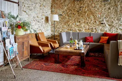 a living room with a couch and a table at Domaine Des Agnelles in Villedaigne