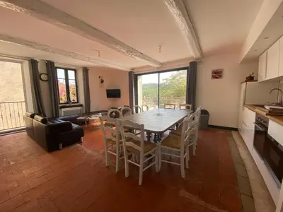 a dining room with a table and chairs at Gîte Du Bourrelier in Boutenac