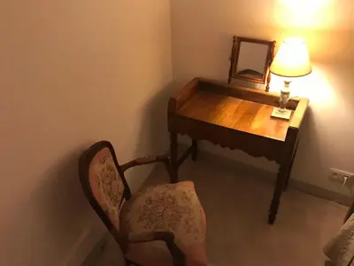 a room with a desk and a chair and a mirror at Gîte Du Bourrelier in Boutenac