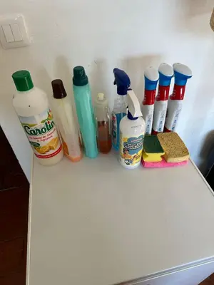 a white table with bottles of condiments on it at Gîte Du Bourrelier in Boutenac