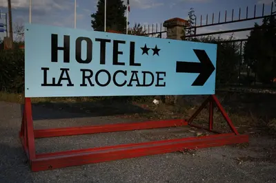 a sign that says hotel la rocca at Hôtel La Rocade in Pamiers