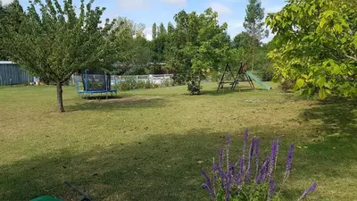 a yard with a playground with a swing at Gite Pourquoi Pas in Montégut-Lauragais