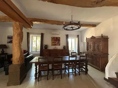 a dining room with a wooden table and chairs at Domaine Les Salices in Azille
