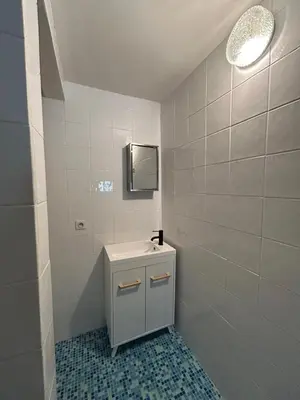 a white bathroom with a sink and a mirror at Domaine Les Salices in Azille