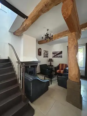 a living room with a staircase and a living room with a couch at Domaine Les Salices in Azille
