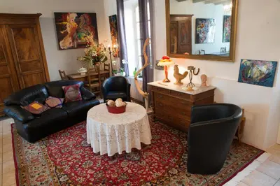 a living room with a couch and a table at Relais de l'Alaric in Moux