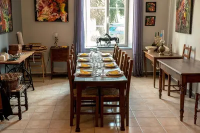 a dining room with a table with plates of food on it at Relais de l'Alaric in Moux