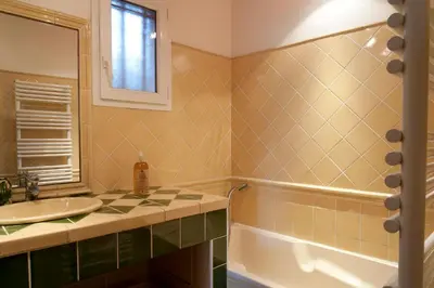 a bathroom with a sink and a tub at Ecuries Sainte Croix in Carcassonne