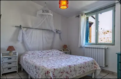a bedroom with a bed and a window at Ecuries Sainte Croix in Carcassonne
