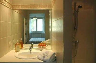 a bathroom with a sink and a mirror at Ecuries Sainte Croix in Carcassonne