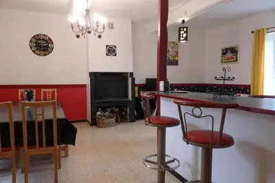 a living room with a bar and a fireplace at La Bonne Planque - Maison éclusière de la Domergue Canal du Midi in Mas-Saintes-Puelles