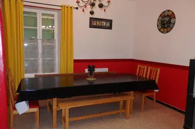 a dining room with a black table and chairs at La Bonne Planque - Maison éclusière de la Domergue Canal du Midi in Mas-Saintes-Puelles