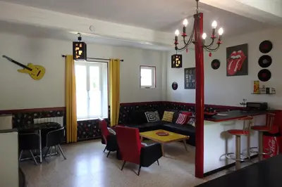 a living room with a couch and a table at La Bonne Planque - Maison éclusière de la Domergue Canal du Midi in Mas-Saintes-Puelles