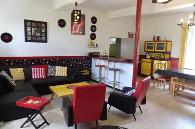 a living room with a couch and a table at La Bonne Planque - Maison éclusière de la Domergue Canal du Midi in Mas-Saintes-Puelles