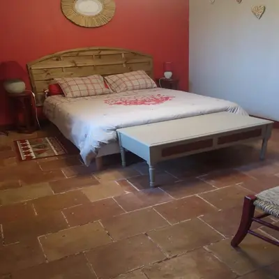 a bedroom with a bed and a table in it at La Bonne Planque - Maison éclusière de la Domergue Canal du Midi in Mas-Saintes-Puelles