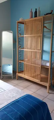 a room with a wooden shelf and a mirror at l'Oulibo in Villeneuve-les-Corbières
