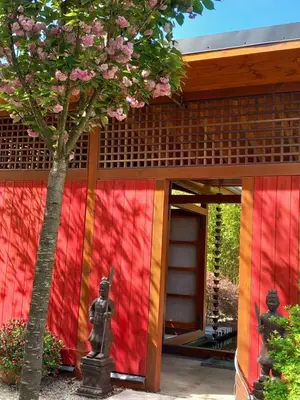 a building with a colorful facade with a statue at l'Oulibo in Villeneuve-les-Corbières