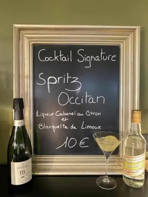 a chalkboard with a bottle and a glass of wine at Hôtel Pont Rouge , Carcassonne in Carcassonne