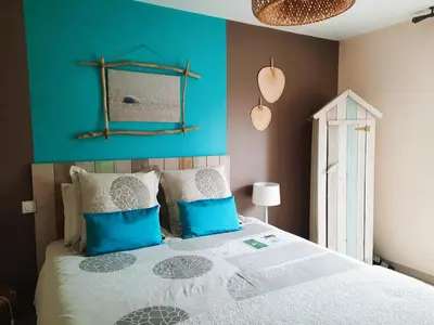 a bedroom with a bed with a blue wall at Belloréade Maison d'hôtes in Belloc