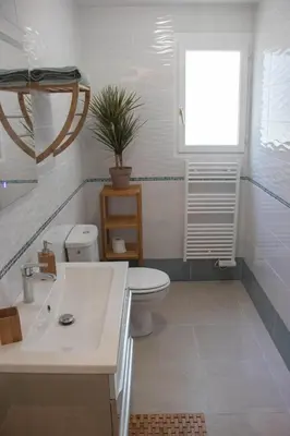a bathroom with a sink and a toilet and a window at Belloréade Maison d'hôtes in Belloc
