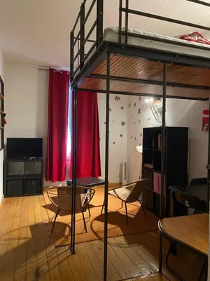 a room with a bunk bed and a table and chairs at Big in Narbonne