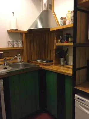 a kitchen with green cabinets and a sink at Big in Narbonne