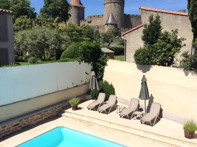 a bathroom with a shower and a toilet and a sink at Hôtel l'Aragon in Carcassonne