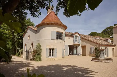 a large white house with a turret at Château Les Carrasses in Capestang