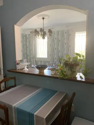 a dining room with a table and a mirror at Le Mazagran proche du centre ville et 15 mn de la plage in Narbonne