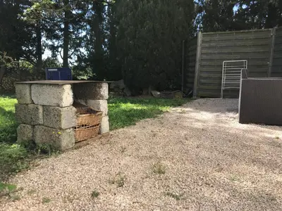 a pile of bricks and a basket in a yard at Maison Majorelle in Moussoulens