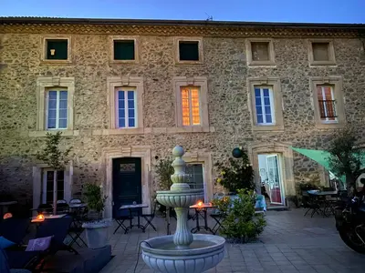 a building with a fountain in front of a building at La Marelle chambre d hôtes à 500m du Canal du Midi in La Redorte