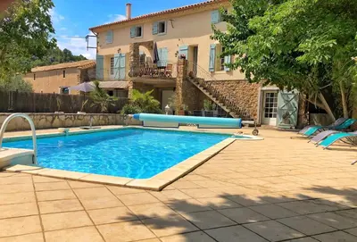 a swimming pool in front of a house at Pradines in Saint-André-de-Roquelongue