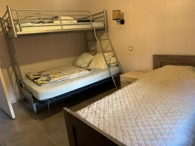 two bunk beds in a room with two beds at Nid douillet in Villemoustaussou