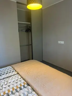a bedroom with a bed with a light above it at Nid douillet in Villemoustaussou