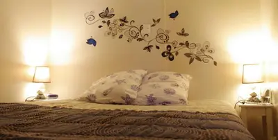 a bedroom with a bed with butterflies on the wall at Camping Sigean in Sigean