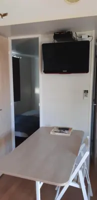 a white table with a tv on top of it at Camping Sigean in Sigean