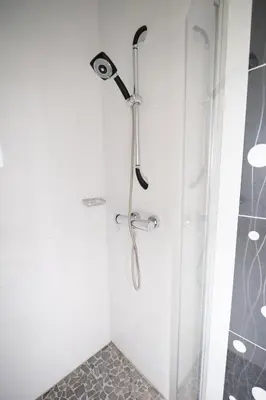 a shower with a shower head in a bathroom at Gîtes Chantelauze in Narbonne