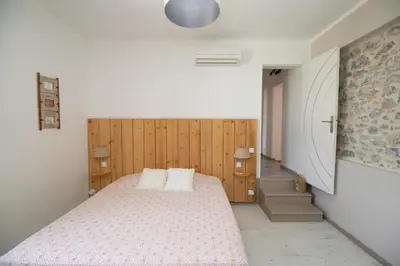 a bedroom with a bed and wooden walls at Gîtes Chantelauze in Narbonne