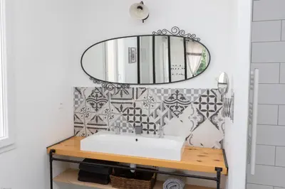 a bathroom with a sink and a mirror at Gîtes Chantelauze in Narbonne