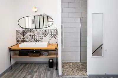 a bathroom with a sink and a mirror at Gîtes Chantelauze in Narbonne