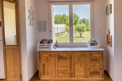 a kitchen with a window and a wooden cabinet at Gîtes Chantelauze in Narbonne