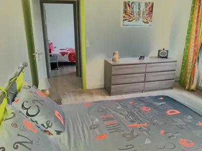 a bedroom with a bed and a dresser and a bedroom with a car at Gîte de Marie in Burlats