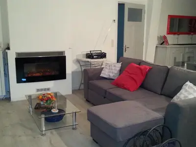 a living room with a couch and a fireplace at Gîte de Marie in Burlats